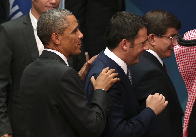 In this Nov. 15, 2014, file photo, U.S. President Barack Obama left, puts his hands on the shoulders of Prime Minister of Italy Matteo Renzi after the family photo session of the G-20 summit in Brisbane, Australia. Obama will host Renzi at the White House on Friday, April 17, 2015, to compare notes on a range of issues, including Ukraine, Libya and Islamic State militants. (AP Photo/Rob Griffith, File)