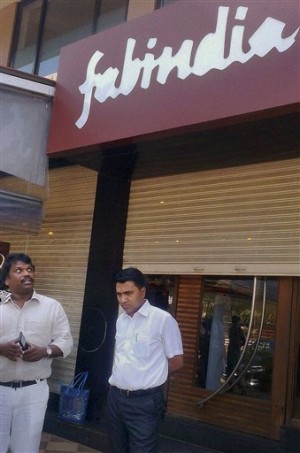 India’s ruling party Bharatiya Janata Party (BJP) MLA's of the state of Goa Michael Lobo, left, and Pramod Sawant stand outside a "Fabindia" showroom in Candolim, India, Friday, April 3, 2015. Police are investigating Human Resources Development Minister Smriti Irani's complaint that the niche boutique in the southwestern resort of Goa had a closed-circuit TV looking into a changing room where she was trying out clothes. AP