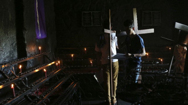 Filipino devotees carry wooden crosses as they make the Stations of the Cross at the Philippine Center of Saint Pio of Pietrelcina on Wednesday, April 1, 2015 in suburban Quezon city, east of Manila, Philippines. Devotees practice different religious rites during the Holy Week in this predominantly Roman Catholic country. (AP Photo/Aaron Favila)