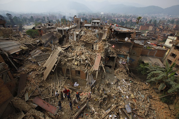 Rescue workers remove debris as they search for victims of earthquake in Bhaktapur near Kathmandu, Nepal, Sunday, April 26, 2015. A strong magnitude earthquake shook Nepal's capital and the densely populated Kathmandu Valley before noon Saturday, causing extensive damage with toppled walls and collapsed buildings, officials said. AP