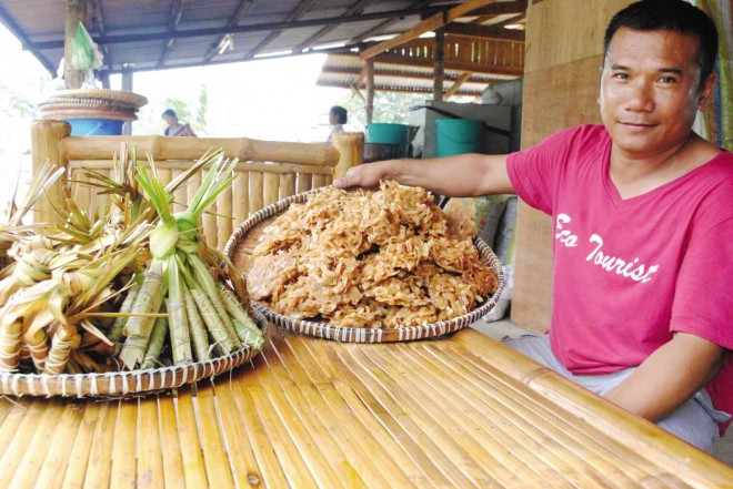 HAROLD Ronquillo, manager of Ronquillo Balete Eco Park, says the native delicacies “pakumbo de balete” and “suman de balete” are best-sellers. 