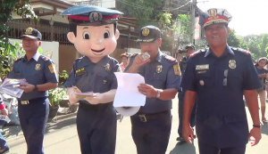 Cops from the Quezon City Police District and mascot PO1 Matapat made the rounds in Teachers Village Wednesday to remind the residents on how they can keep their homes safe during the Holy Week. PHOTO BY NOY MORCOSO/INQUIRER.net