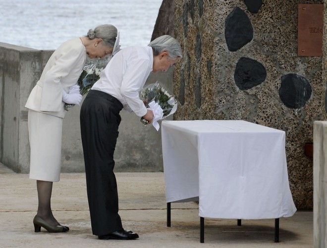 Emperor Akihito and Empress Michiko offer flowers in front of the cenotaph on Pelelilu island in Palau Thursday, April 9, 2015. The emperor of Japan is visiting a remote Pacific island to pray for thousands of Japanese and American soldiers who died during the World War II battle of Pelelilu.(AP Photo/Kyodo News) JAPAN OUT, MANDATORY CREDIT