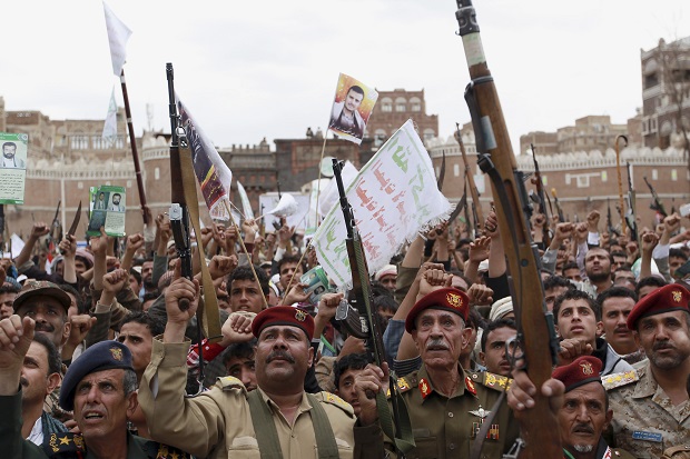 Shiite rebels, known as Houthis, hold up their weapons to protest against Saudi-led airstrikes, during a rally in Sanaa, Yemen, Thursday, March 26, 2015. Saudi Arabia bombed key military installations in Yemen on Thursday, leading a regional coalition in a campaign against Shiite rebels who have taken over much of the country and drove out the president. (AP Photo/Hani Mohammed)