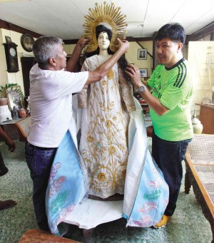 ALBERT Abaya, village chief of San Antonio in Candon City, Ilocos Sur, prepares the statue of the Mater Dolorosa (Sorrowful Mother). LEONCIO BALBIN JR./Contributor