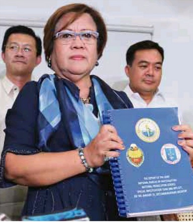 Justice Secretary Leila de Lima holds the 224-page report on the Mamasapano clash prepared by the justice department’s special investigation team, during a press conference on April 16, 2015. RAFFY LERMA/INQUIRER FILE PHOTO