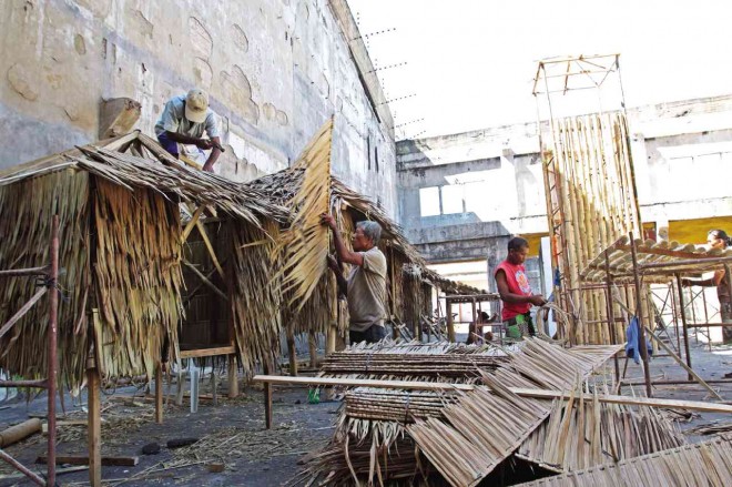 CARPENTERS build nipa huts and other props that will be used in the “Kaplag” reenactment next week. JUNJIE MENDOZA/CEBU DAILY NEWS