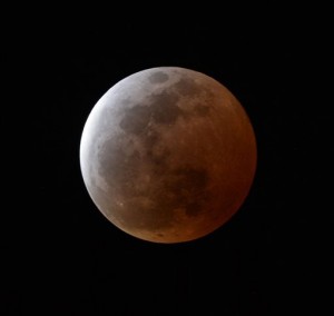 A total lunar eclipse is observed in Urasoe city, Okinawa prefecture, southern Japan, Saturday, April 4, 2015. (AP Photo/Kyodo News)