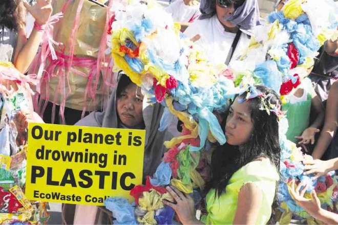 ENVIRONMENTAL advocates from EcoWaste Coalition call for a nationwide ban on the use of plastic bags in front of the Quiapo Church in Manila on Monday.  NIÑO JESUS ORBETA 