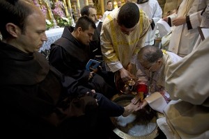Latin Patriarch of Jerusalem, Fouad Twal, right, washes a monks feet during the Washing of the Feet ceremony at the Church of the Holy Sepulchre, traditionally believed by many to be the site of the crucifixion and burial of Jesus Christ, in Jerusalem's Old City, Thursday, April 2, 2015. AP FILE PHOTO