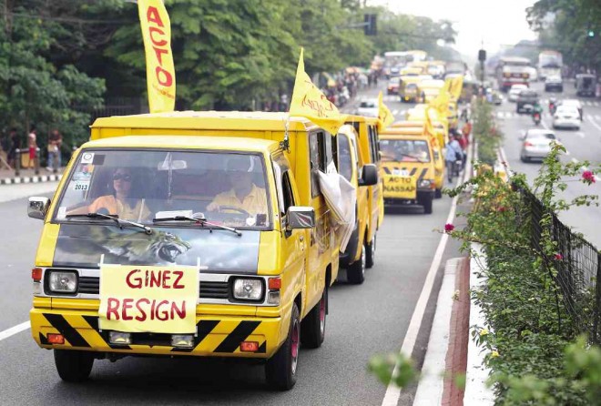 MORE TIME Transport operators roll out a protest caravan Thursday in Quezon City to seek a delay in the enforcement of the age limit on vehicles used as school shuttles. LYN RILLON