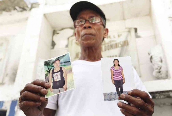 MARCIANO Apostol, 55, came to the cemetery with photos of his daughter Mary Liza, one of the victims of the  Kentex factory fire. RAFFY LERMA 