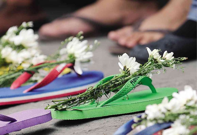 The factory disaster provided a new rallying cry for militant labor groups who used the workers’ products—slippers—to express their condolences and indignation. PHOTOS BY RAFFY LERMA
