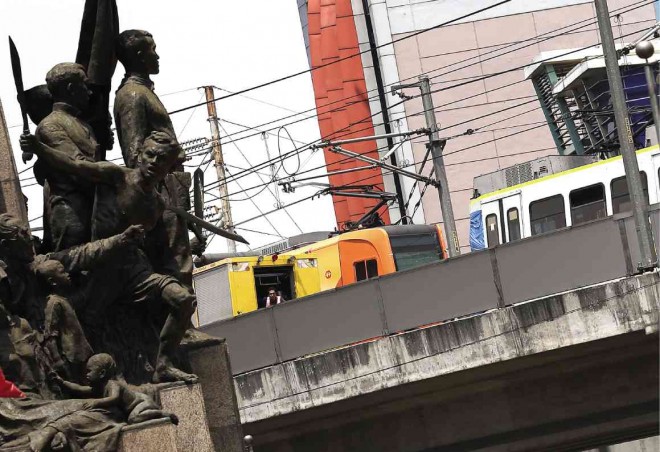 SYSTEM OR HUMAN ERROR?  The two colliding LRT1 trains at Monumento station Saturday. RAFFY LERMA