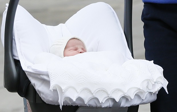 Britain's Prince William and Kate, Duchess of Cambridge, hold their newborn daughter as they as they pose for the media outside St. Mary's Hospital's exclusive Lindo Wing, London, Saturday, May 2, 2015. The Duchess gave birth to the Princess on Saturday morning. (AP Photo/Kirsty Wigglesworth)