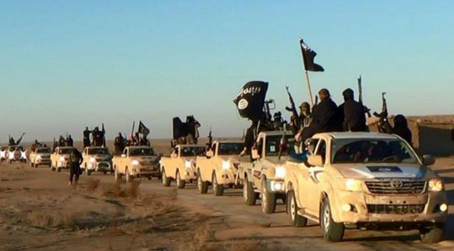 FILE - In this undated file photo released by a militant website, which has been verified and is consistent with other AP reporting, militants of the Islamic State group hold up their weapons and wave its flags on their vehicles in a convoy on a road leading to Iraq, while riding in Raqqa city in Syria. The notion that young women are traveling to Syria solely to become "jihadi brides" is simplistic and hinders efforts to prevent other girls from being radicalized, new research suggests. Young women are joining the so-called Islamic State group for many reasons, including anger over the perceived persecution of Muslims and the wish to belong to a sisterhood with similar beliefs, according to a report released Thursday, May 28, 2015, by the Institute for Strategic Dialogue and the International Center for the Study of Radicalization at King's College London. (Militant website via AP, file)