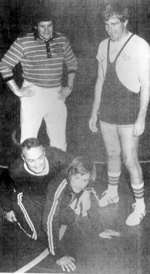 In this Oct. 25, 1975 photo, taken from a newspaper page, Yorkville, Ill., high school wrestling coach and former U.S. House Speaker Dennis Hastert, top left, and Illinois State University wrestling coach Larry Meyer, top right, watch as University High School coach George Girardi, bottom left, demonstrates a move on Yorkville assistant Tony Houle at a technical wrestling clinic in Bloomington, Ill. A newly unveiled indictment against Hastert accuses the Republican of agreeing to pay $3.5 million in hush money to keep a person from the town where he was a longtime schoolteacher silent about "prior misconduct." (The Pantagraph via The AP)