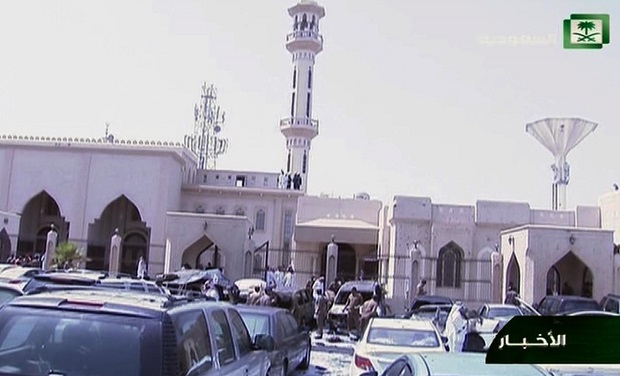 In this still image taken from video provided by Saudi TV, investigators collect evidence at the scene of a suicide bombing, outside the the Imam Hussein mosque, in the port city of Dammam, Saudi Arabia, Friday, May 29, 2015.  A suicide bomber blew himself up in the parking lot of a Shiite mosque in eastern Saudi Arabia during Friday prayers, killing four people in the second such attack in as many weeks claimed by the Islamic State group. (Saudi Television via AP) SAUDI ARABIA OUT
