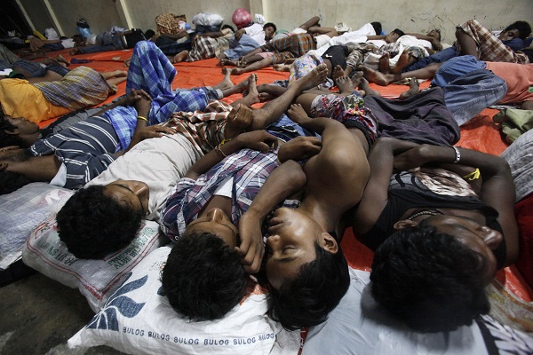 Migrants sleep at a temporary shelter in Langsa, Aceh province, Indonesia, Sunday, May 17, 2015. Boats filled with more than 2,000 Bangladeshi and Rohingya migrants have landed in Indonesia, Malaysia and Thailand, and thousands more migrants are believed to be adrift at sea after a crackdown on human traffickers prompted captains and smugglers to abandon their human cargo. AP