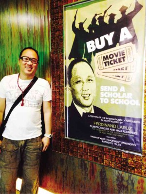 LAPUZ stands beside a poster of the recent film festival that raised P300,000 for scholarships.