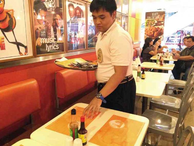 AT PANCAKE House Megamall,  ILLC graduate Ramon is a server and greeter.