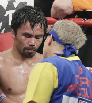 Manny Pacquiao, left, stands with trainer Freddie Roach at the finish of his welterweight title fight against Floyd Mayweather Jr. on Saturday, May 2, 2015 in Las Vegas. AP