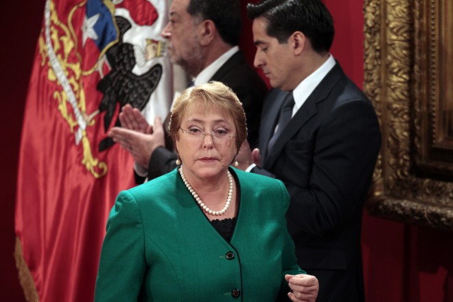 In this Monday, May 11, 2015, file photo, Chile's President Michelle Bachelet attends a ceremony announcing new Cabinet members at the presidential palace La Moneda, in Santiago, Chile. President Bachelet reshuffled her cabinet to stem the fallout from revelations her son used his influence to secure a favorable loan. The scandal has prompted widespread outrage with the sway of money over politics in a country long dominated by the president’s socialist party although opposition parties are also facing rebuke. (AP Photo/Luis Hidalgo, File