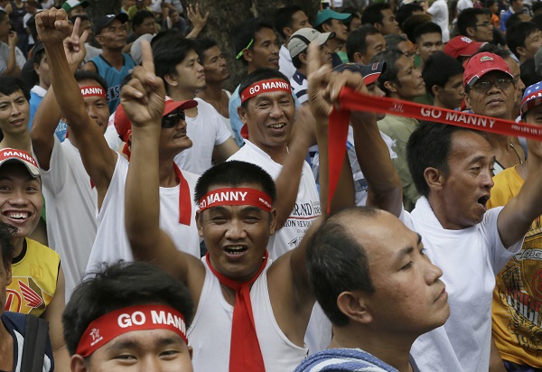 Filipinos, wearing red headbands, cheer as they wait for the round-by-round live satellite broadcast from Las Vegas of the welterweight boxing title fight between the Philippines' Manny Pacquiao and American Floyd Mayweather Jr. Sunday, May 3, 2015 at suburban Marikina city east of Manila, Philippines. Pacquiao lost to Mayweather Jr., via a unanimous decision.  AP