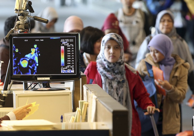 A thermal camera monitor shows the body temperature of passengers arriving from overseas against possible MERS, Middle East Respiratory Syndrome, virus at the Incheon International Airport in Incheon, South Korea Thursday, May 21, 2015. South Korea said Thursday it has confirmed three cases of a respiratory virus that has killed hundreds of people in Saudi Arabia. AP