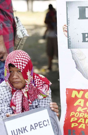 SECURITY preparations for Apec are in place not only for terror threats, but also to keep off protesters like this woman at a rally against Apec in Clark in Pampanga province. MARIANNE BERMUDEZ 