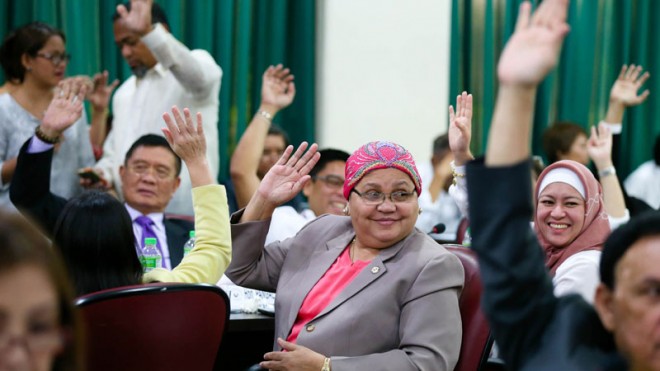GIVING BBL A HAND  Supporters of the Bangsamoro Basic Law in the House of Representatives signify their approval of some provisions with a show of hands during the second day of voting. Backing the controversial proposed law are (from left) Representatives Pangalian Balindong, Maryam Arbison and Sitti Djalia Turabin-Hataman.  LYN RILLON