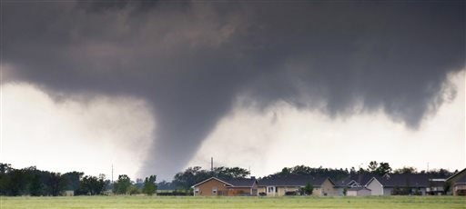 A tornado passes near Halstead, Kan., Wednesday, May 6, 2015. A swath of the Great Plains is under a tornado watch Wednesday, including parts of North Texas, Oklahoma, Kansas and Nebraska. (Travis Heying/The Wichita Eagle via AP)