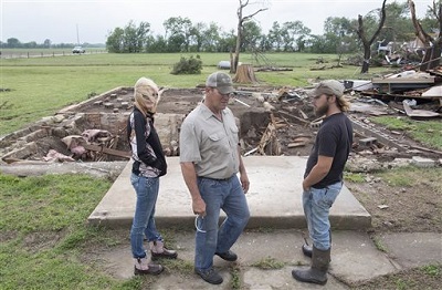 Neighbors of Craig Foraker check out his property after a tornado devastated the area near Bentley, Kan., Wednesday May 6, 2015. A swath of the Great Plains is under a tornado watch Wednesday, including parts of North Texas, Oklahoma, Kansas and Nebraska. (Travis Heying/The Wichita Eagle via AP) LOCAL TELEVISION OUT; MAGS OUT; LOCAL RADIO OUT; LOCAL INTERNET OUT
