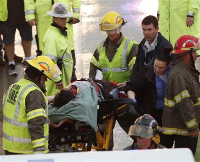First responders take a passenger of a truck involved in an accident on Interstate 35 during severe weather to an ambulance, in Moore, Okla., Wednesday, May 6, 2015. (AP Photo/Sue Ogrocki)