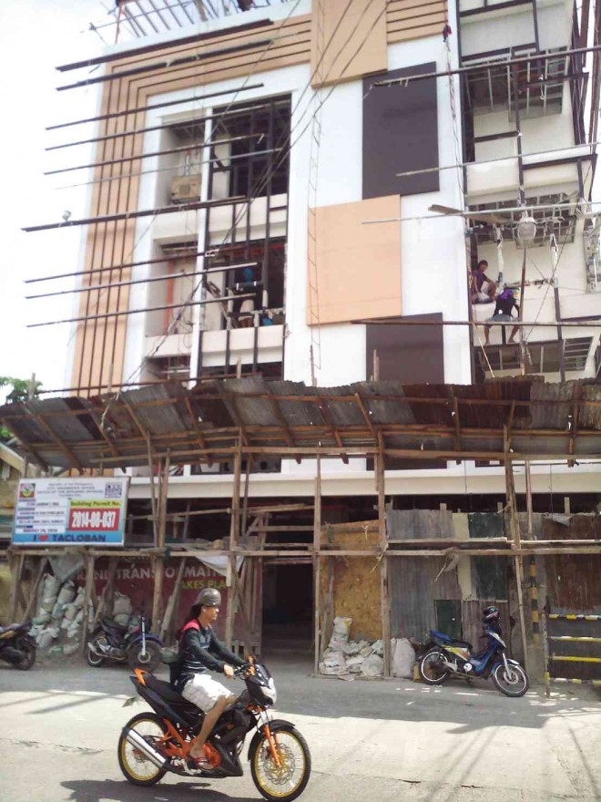 AFTER Supertyphoon “Yolanda,” Tacloban is going through a construction boom of sorts with new commercial structures being built around the city.JOEY GABIETA/INQUIRER VISAYAS