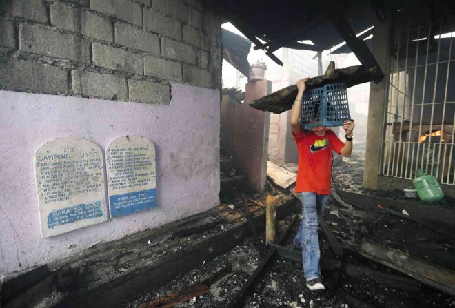 MOCK tablets of the Ten Commandments on a chapel’s wall remained untouched by the fire which hit Barangay Matandang Balara in Quezon City, on  Wednesday morning. Lyn Rillon