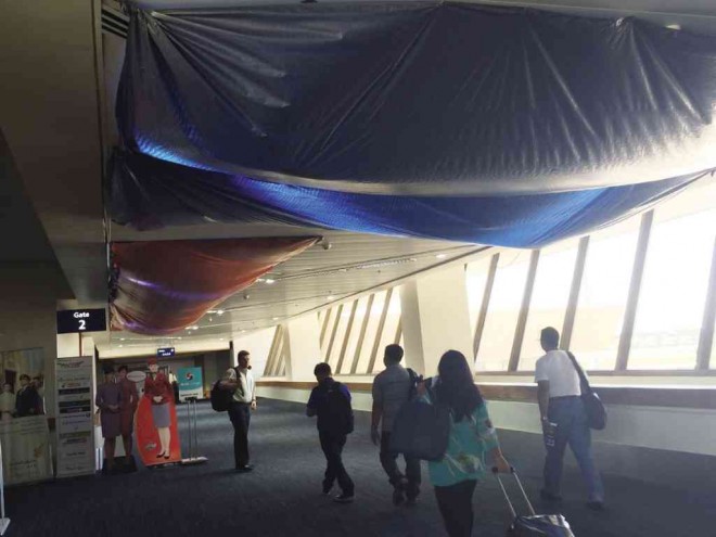 WET GOOD-BYES The dripping ceiling of a walkway at the departure area of the (supposedly) newly renovated Naia Terminal 1 is temporarily remedied by tarpaulins to keep passengers dry, in this photo taken on June 1. Jeannette I. Andrade 