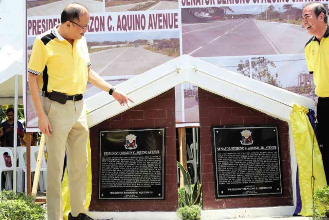 AVENUES FOR GOOD GOVERNANCE  President Aquino seems pleasantly surprised at finding two national roads in Iloilo province named after his parents—the 14.8-km President Corazon C. Aquino Avenue and the 15.6-km Sen. Benigno Aquino Jr. Avenue. At right is DPWH Secretary Rogelio Singson.  GRIG MONTEGRANDE