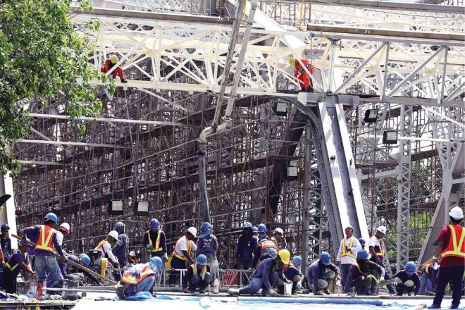 P447-M REHAB With its last major repair works done in 1957, Ayala Bridge was reinforced to hopefully withstand a strong earthquake and raised by 70 cm to allow more headroom for barges and other vessels in the Pasig River. Workers concentrate on a section on Thursday. JOAN BONDOC 