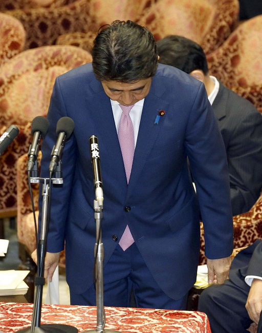 Japanese Prime Minister Shinzo Abe bows at the start of a parliamentary session in Tokyo Monday as he apologized for yelling at an opposition lawmaker during her question last week. AP 