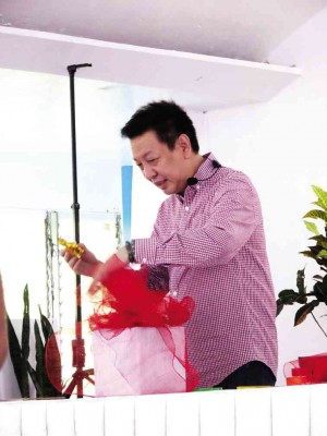 CUNA (above) attaches Chinese lucky figures to a gift appropriate for the lunar new year