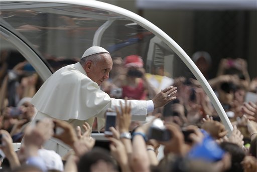 Pope Francis waves as he arrives at the Santa Maria Ausiliatrice Basilica in Turin, Italy, Sunday, June 21, 2015. Pope Francis earlier prayed in front of the Holy Shroud, the 14 foot-long linen revered by some as the burial cloth of Jesus, on display at the Cathedral of Turin.  AP PHOTO/LUCA BRUNO