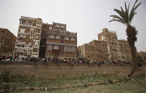 People gather to look at houses destroyed by Saudi airstrikes in the old city of Sanaa, Yemen, Friday, June 12, 2015. AP