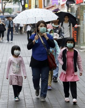 Tourists wear masks as a precaution against MERS virus at a shopping district in Seoul, South Korea, Friday, June 5, 2015.