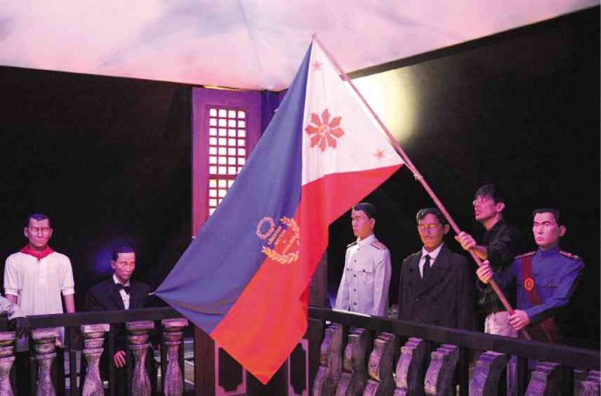 FIRST FLAG This artist rendition of the creation of the first Philippine Flag is featured in a Baguio museum that stores the actual relic. Emilio Aguinaldo Suntay III, great grandson of the late former president Emilio Aguinaldo, says fabrics and materials were purchased from Hong Kong.EV ESPIRITU/INQUIRER NORTHERN LUZON 