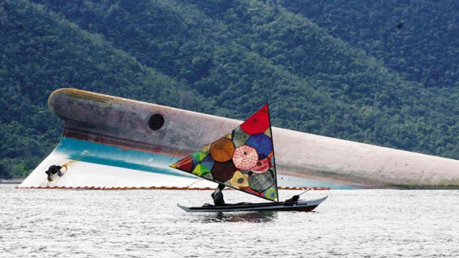 POSEIDON’S WRATH File photo taken on June 25, 2008, shows a small boat with a colorful sail passing by the hull of the Princess of the Stars four days after the Sulpicio Lines vessel capsized in the Sibuyan Sea at the height of Typhoon “Frank.”  INQUIRER FILE PHOTO 
