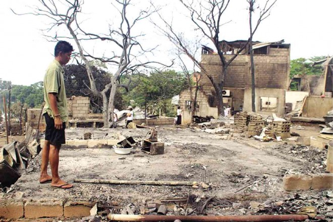 A MAN STANDS on what used to be his house in the village of Manoc-Manoc in Boracay, which was hit by a fire that destroyed the resort-island’s wet market and at least 100 houses. KAREN BERMEJO/INQUIRER VISAYAS 