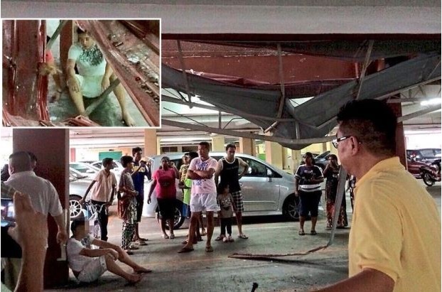 Miraculous escape: Residents checking on the dazed man (inset) after he fell from the eighth floor of a condominium in Bagan Jermal. 