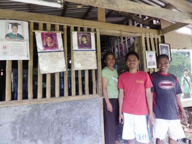GRADUATION pictures of the Taywan children are displayed in their house in Barangay Paitan in Naujan, Oriental Mindoro province. PHOTOS BY MADONNA T. VIROLA 