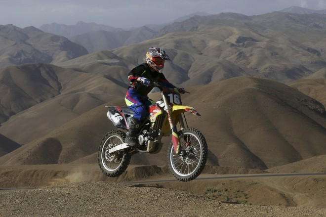 In this photo taken Friday, June 5, 2015, Behnaz Shafiei rides her motocross bike during her training session at a racetrack in the Alborz mountain range near the village of Baraghan, some 19 miles (30 kilometers) west of the capital Tehran, Iran. Shafiei fell in love with motorcycles 11 years ago when she saw a countrywoman running errands on a small bike. AP